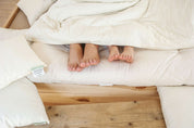 Feet Sticking out of Wool Duvet