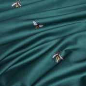 Close up of embroidered bees in the Emerald Honey Bee Bedding Set