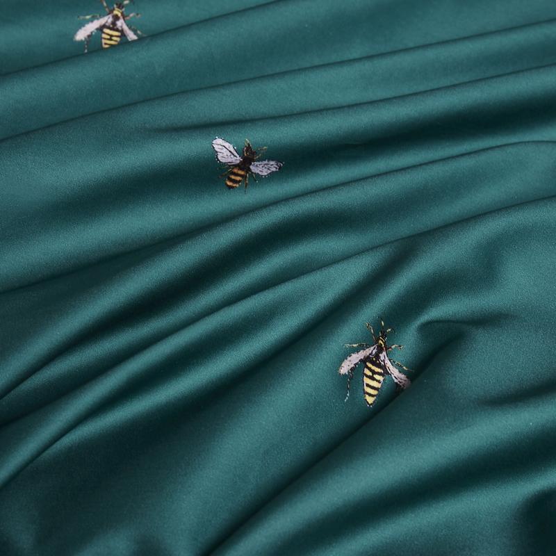 Close up of embroidered bees in the Emerald Honey Bee Bedding Set