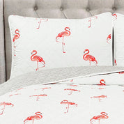 Floral-patterned pillowcases on a bed with a gray headboard.