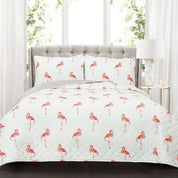 Flamingo patterned bedding set on a bed with a gray headboard.