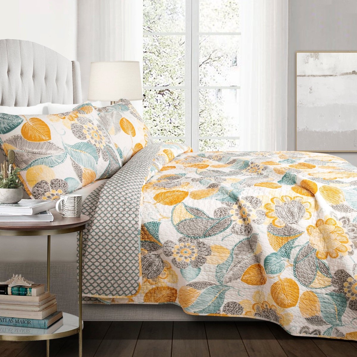 Floral patterned comforter on a bed in a bright bedroom