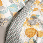 Close-up of patterned fabric with leaf design on a neutral background
