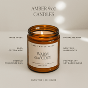 Amber 9 oz candle with 'Warm and Cozy' label on a neutral background