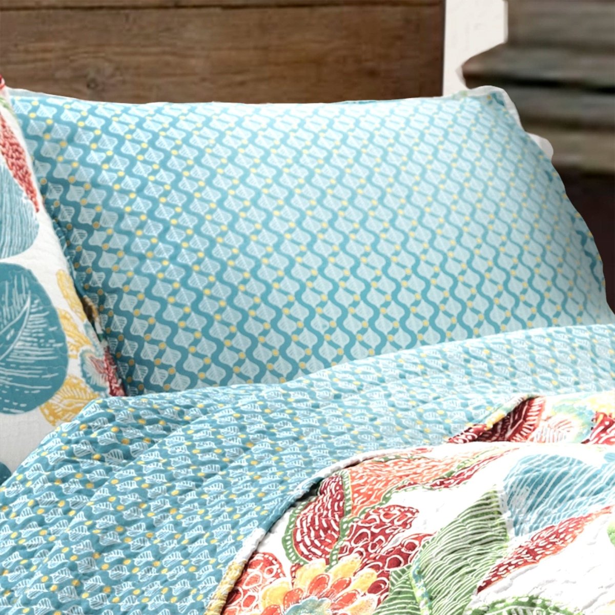 Close-up of a bed with colorful bedding and pillows.