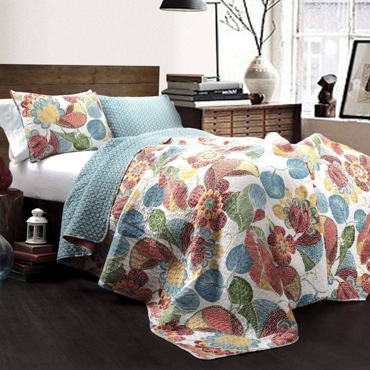 Floral patterned quilt on a bed in a bedroom setting