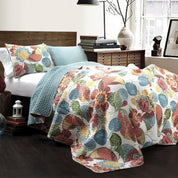 Floral patterned quilt on a bed in a bedroom setting