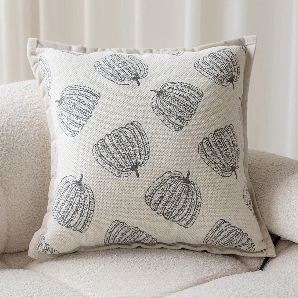 Decorative pillow with pumpkin pattern on a beige sofa