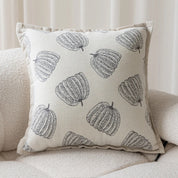 Decorative pillow with pumpkin pattern on a beige sofa