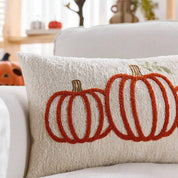 Decorative pillow with pumpkin design on a couch