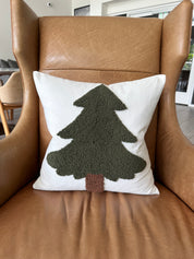 Decorative pillow with a tree design on a brown leather chair