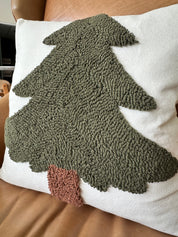 Decorative pillow with a textured green tree design on a white background