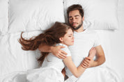 Couple Laying in Luxura Cotton Sheets