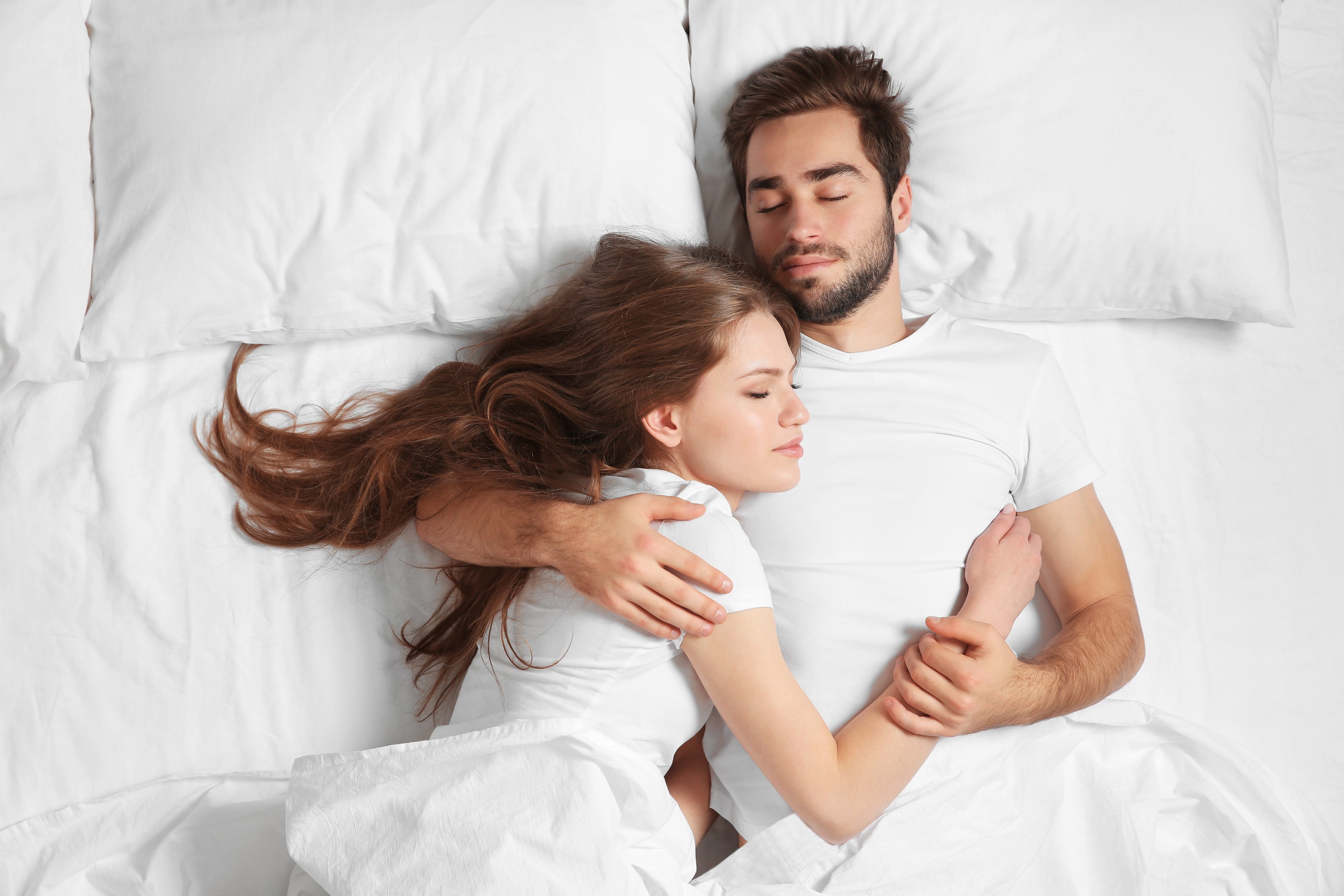 Couple Laying in Luxura Cotton Sheets