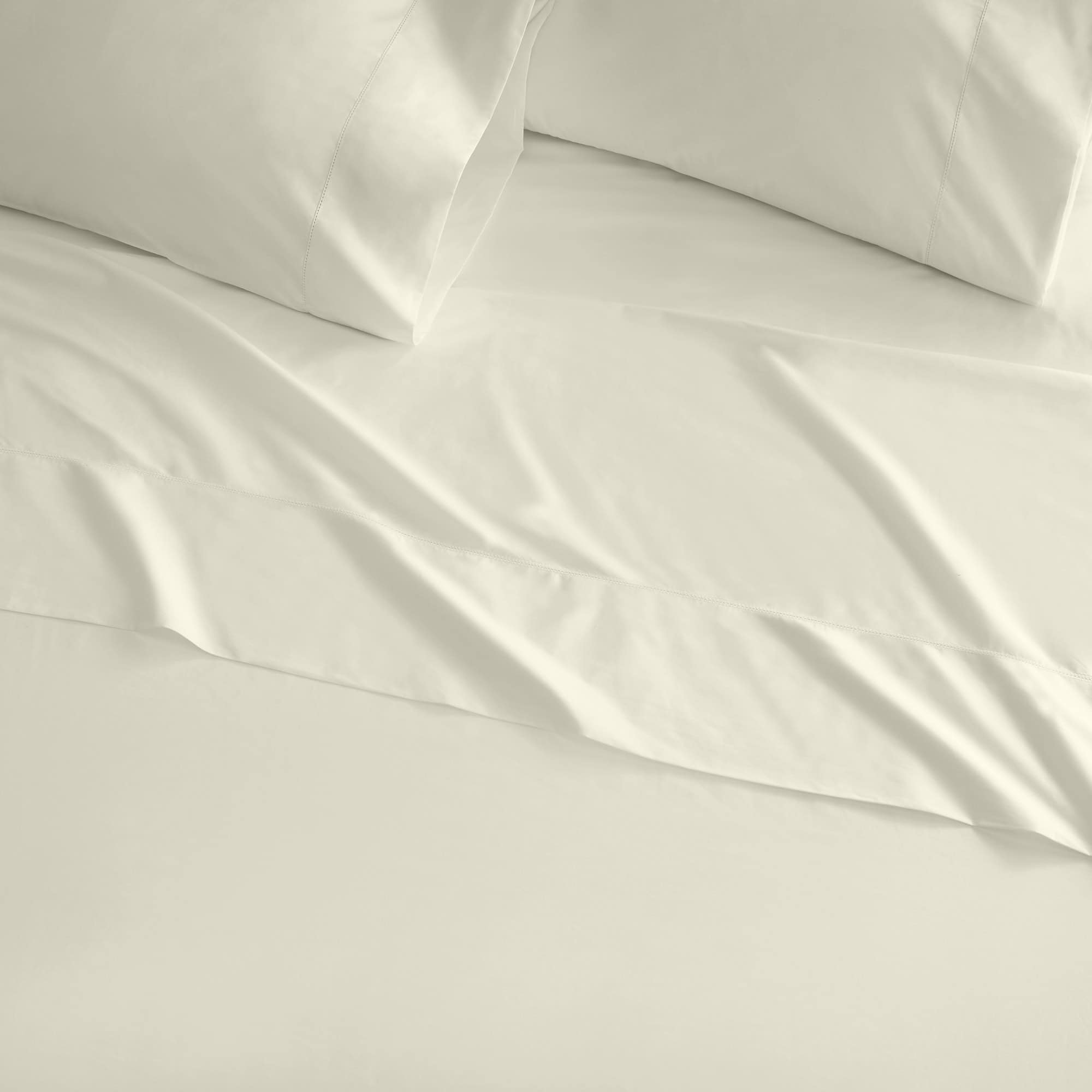 Close-up of light gray bedding with pillows