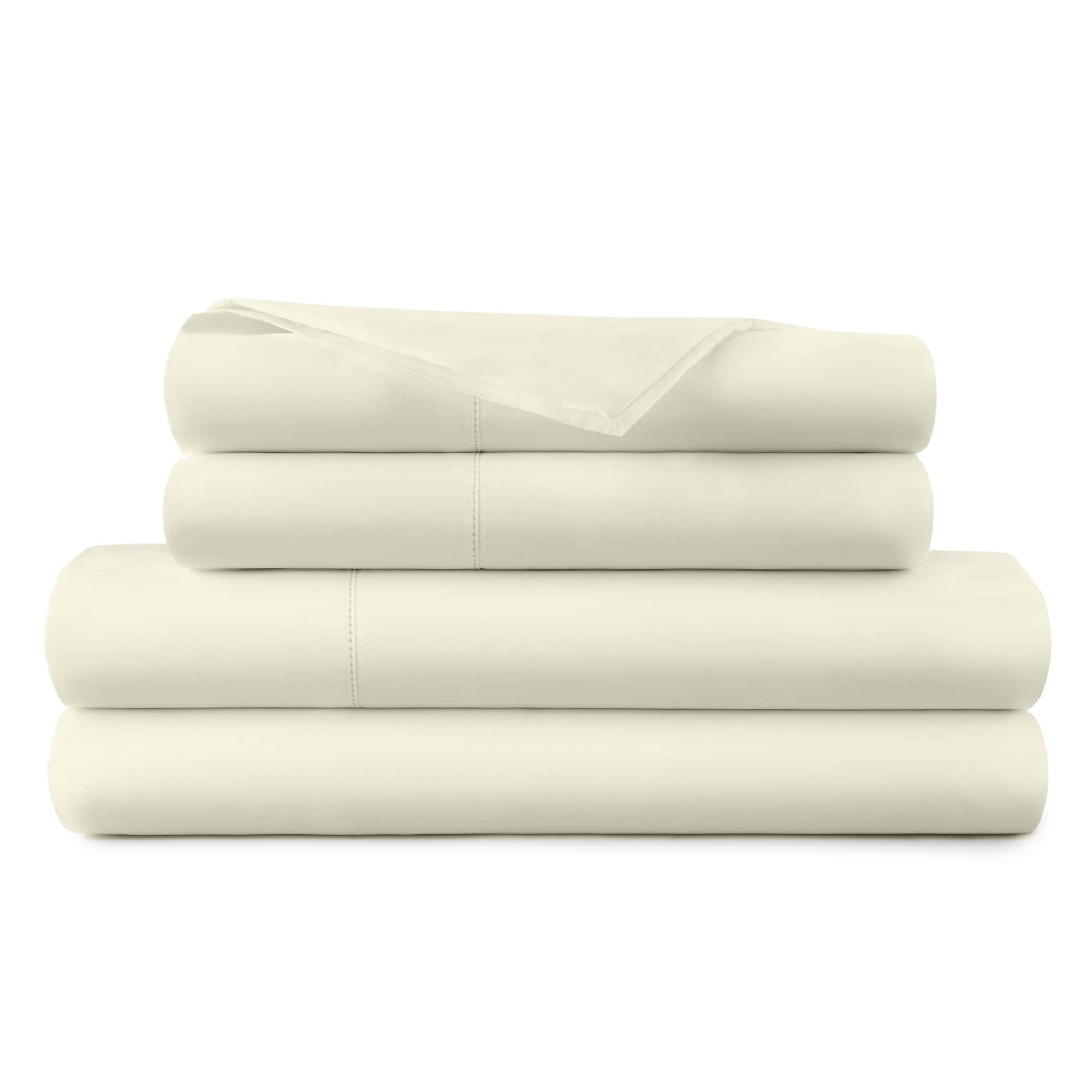 Stack of beige bed sheets on a white background