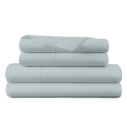Stack of light blue bed sheets on a white background