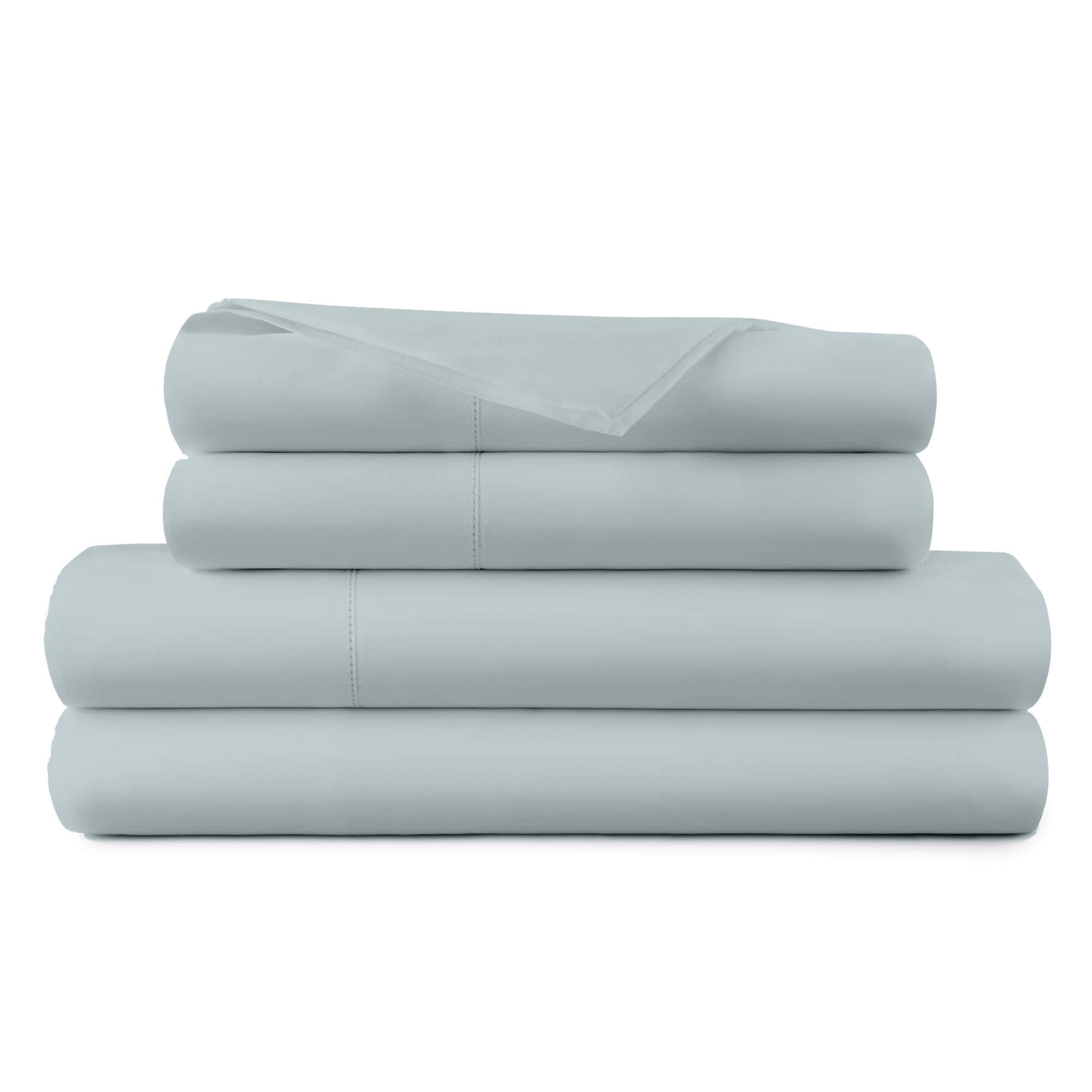 Stack of light blue bed sheets on a white background