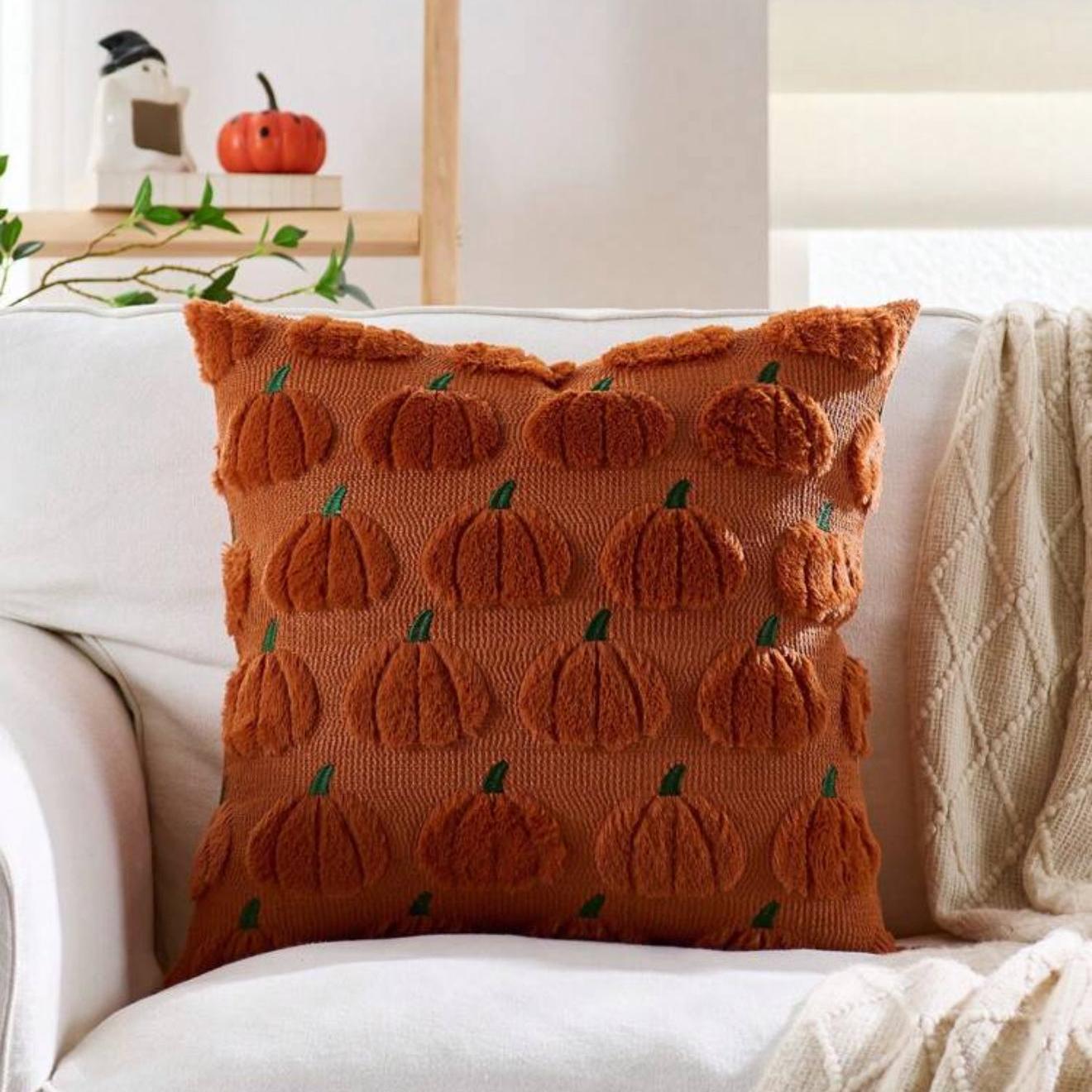 Decorative pillow with pumpkin pattern on a white couch