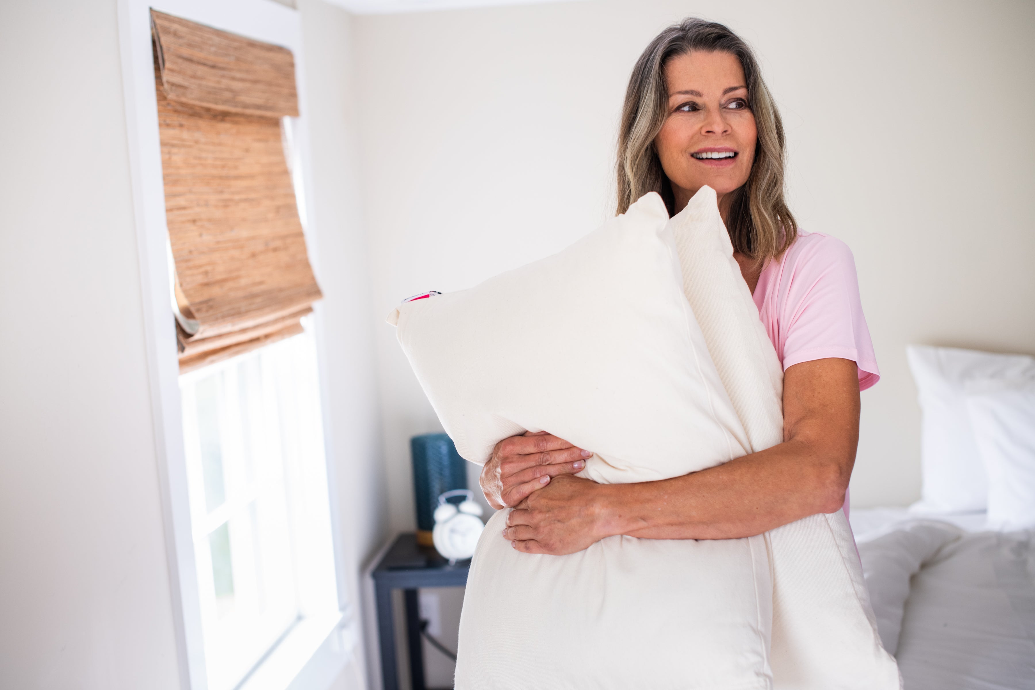 Woman_Holding_Pillows_Bed_Pillow_Natural_Cotton_Wool_Fill_Made_in_USA.jpg