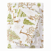 Woodland-themed fabric with trees, deer, and branches on a white background