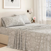 Bed with gray patterned bedding in a bedroom setting
