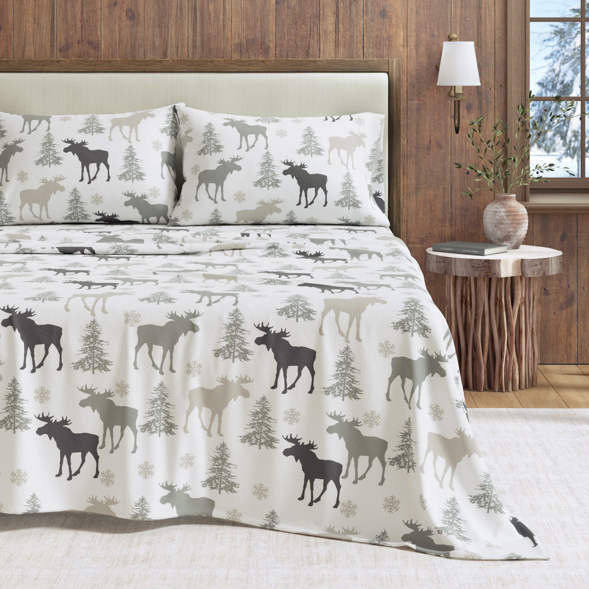 Bedding set with moose and tree pattern in a bedroom setting