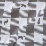 Checkered fabric with wolf and tree silhouettes on a gray and white background