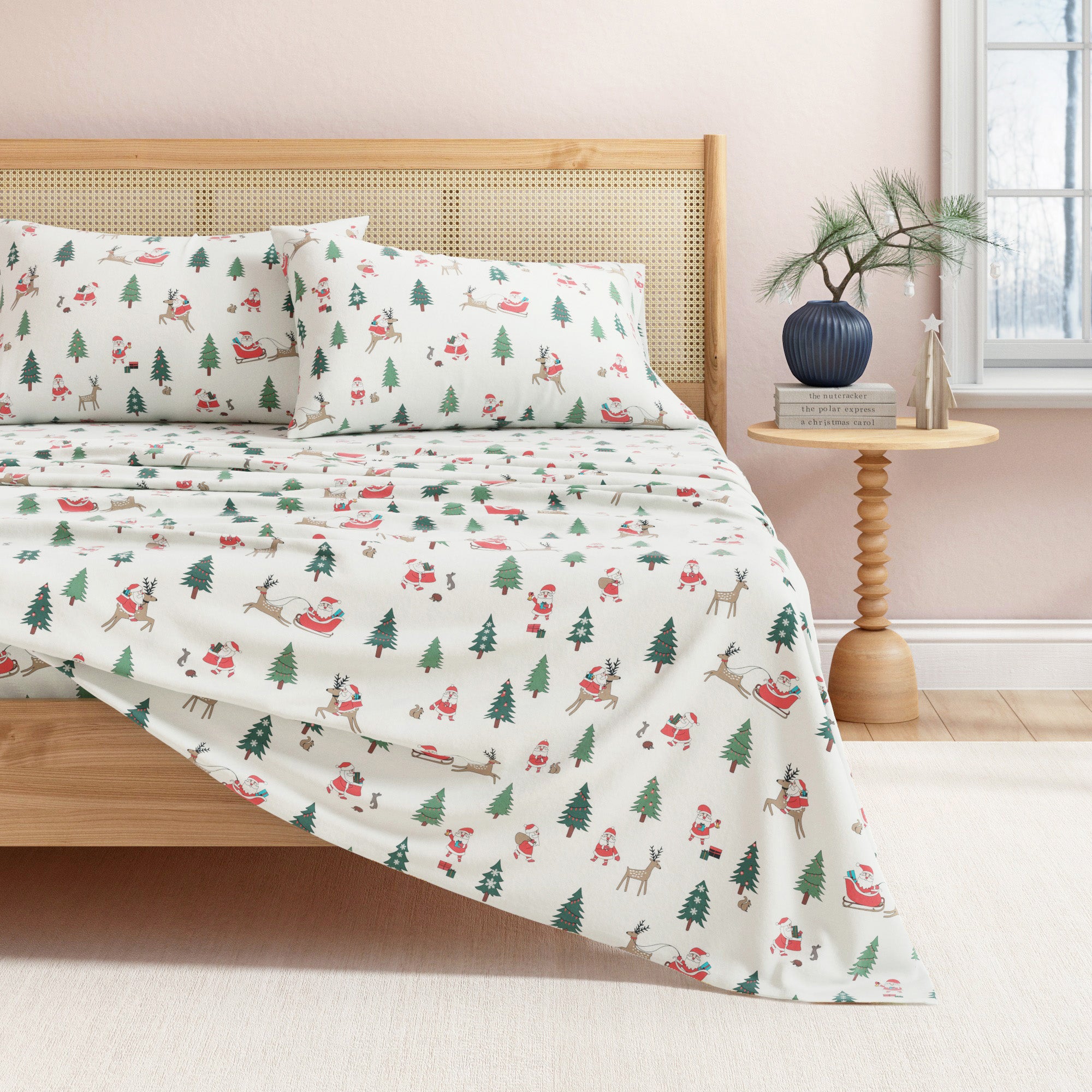 Christmas-themed bedspread on a bed with a wooden headboard and side table.