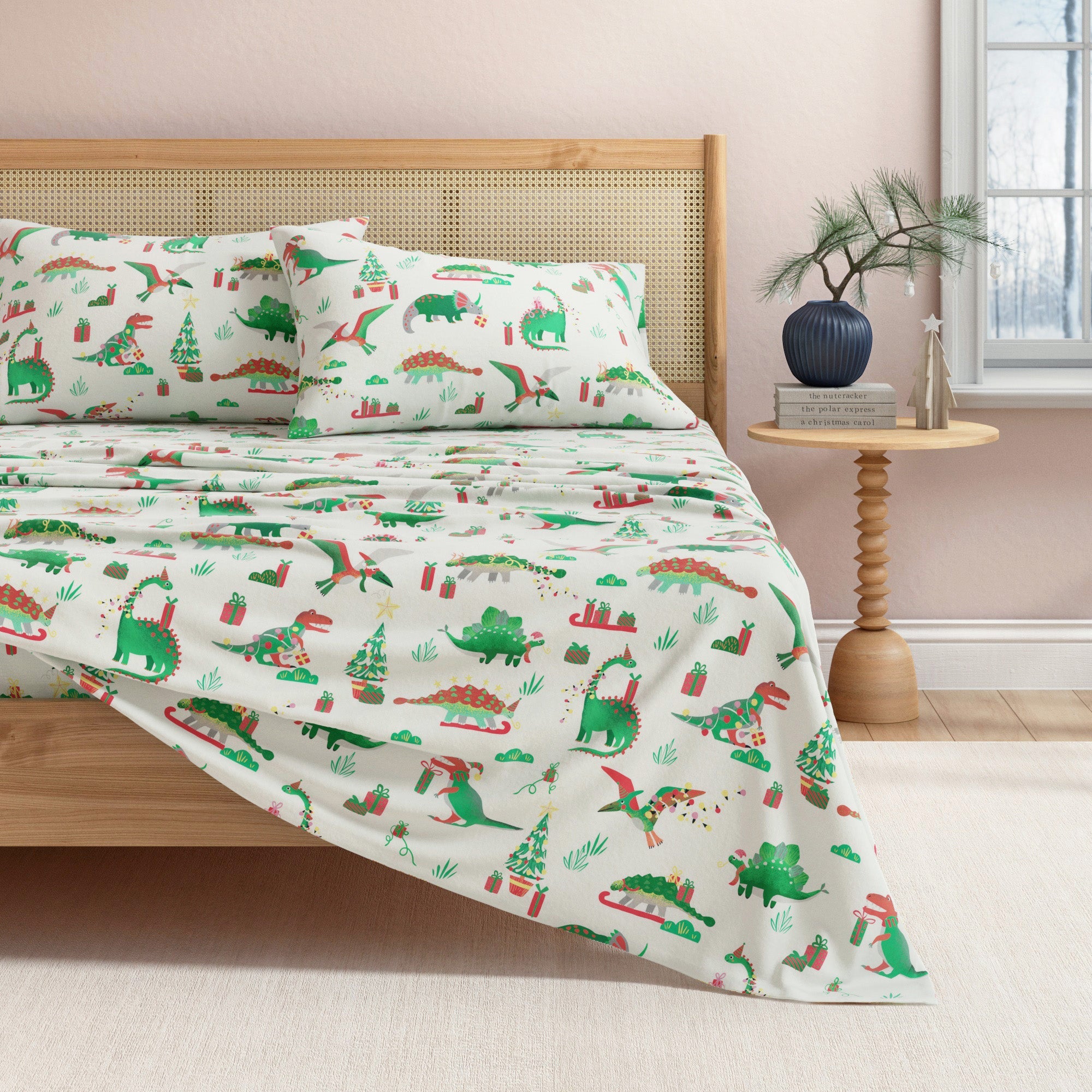 Dinosaur-themed bedspread on a bed in a bedroom setting