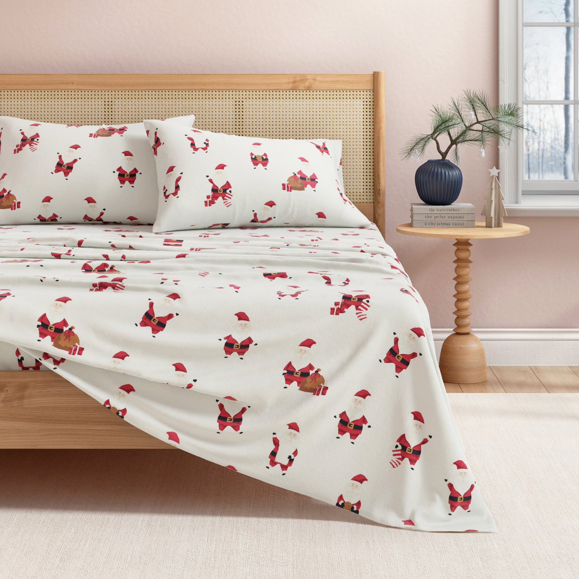 Bed with Santa-patterned bedding in a bedroom setting