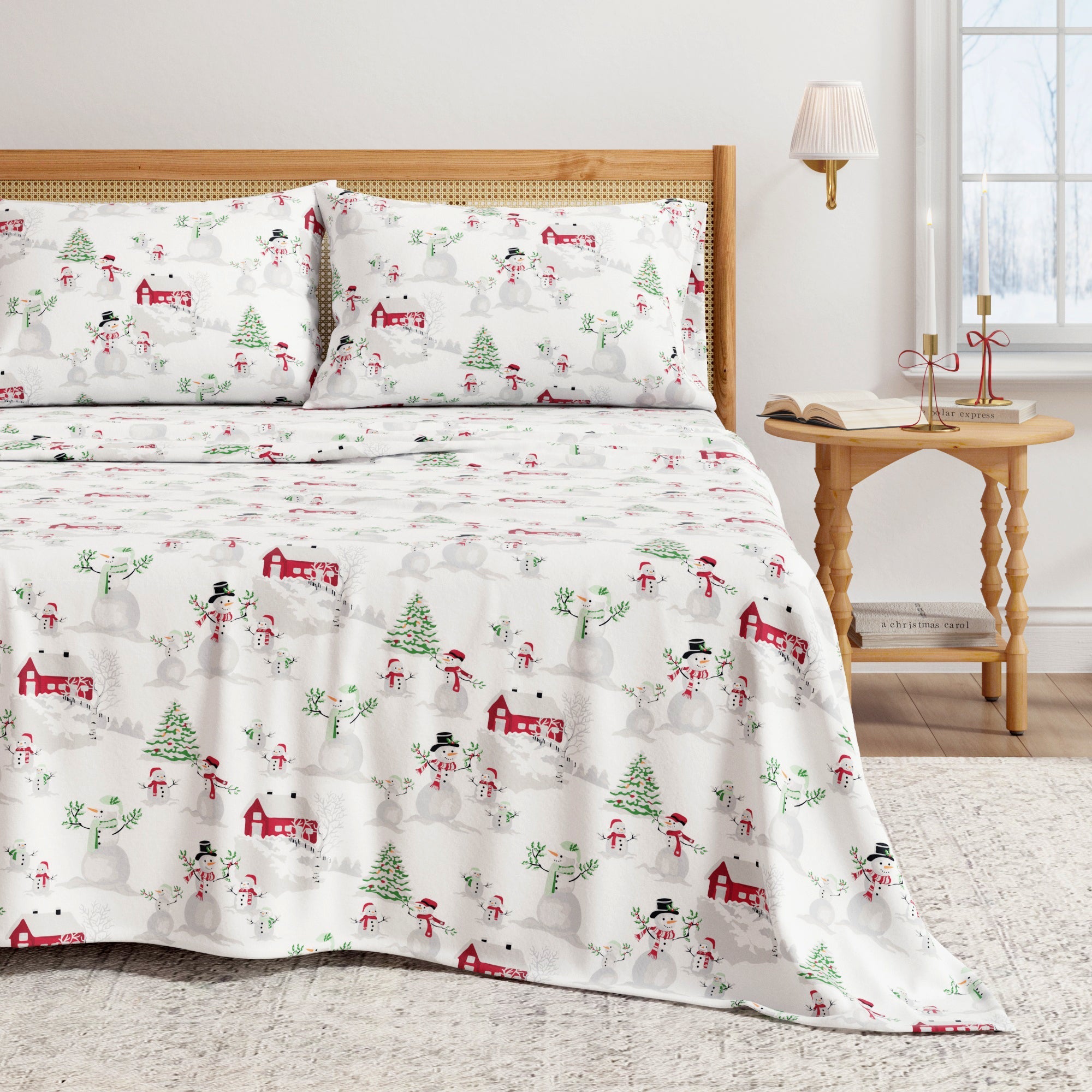 Christmas-themed bedspread with snowmen, trees, and houses on a bed in a bedroom setting.
