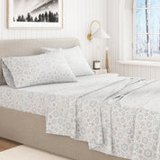 Bed with floral-patterned bedding in a bright bedroom