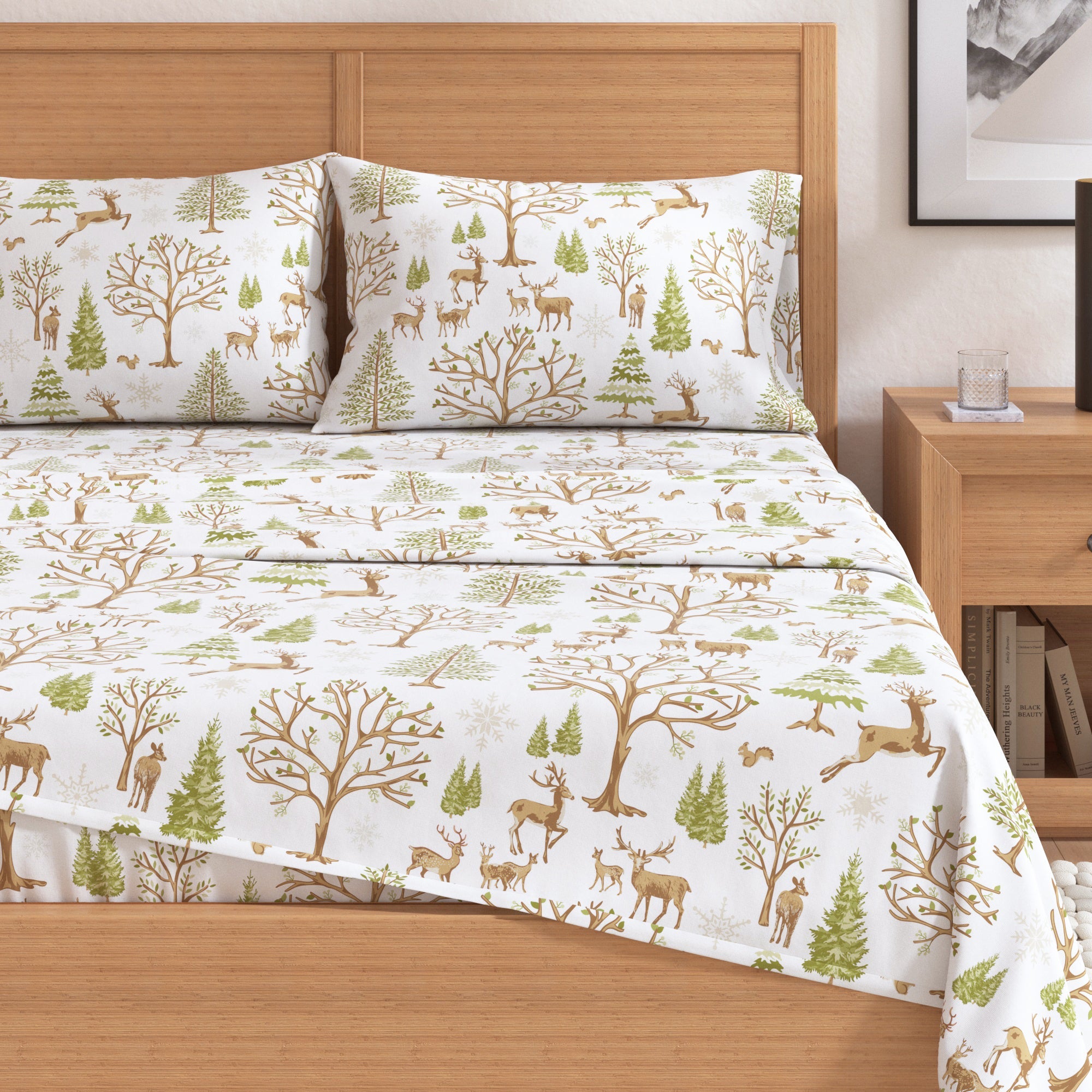 Bedding set with forest design on a bed in a bedroom setting.