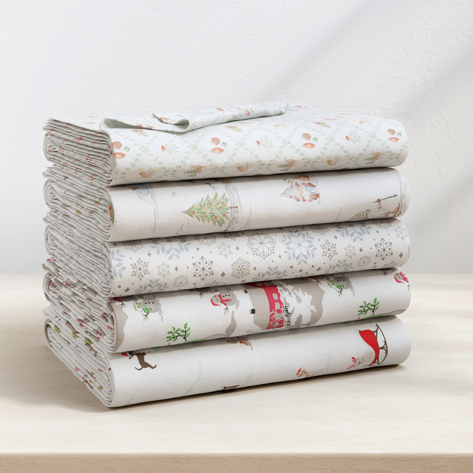 Stack of folded fabric sheets with animal pattern on a white surface