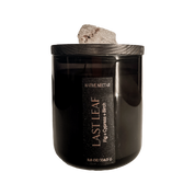 Black candle with wooden lid labeled 'Last Leaf' on a white background