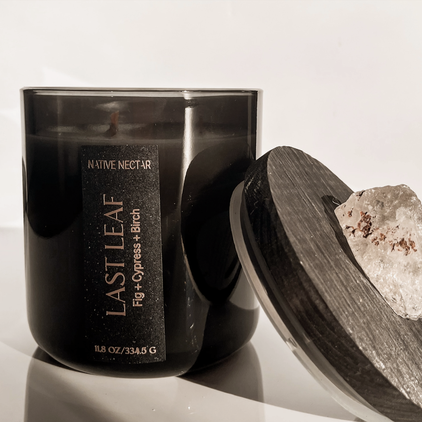 Black candle jar with 'Last Leaf' branding on a white background
