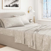 Neatly made bed with light-colored bedding in a bedroom setting.