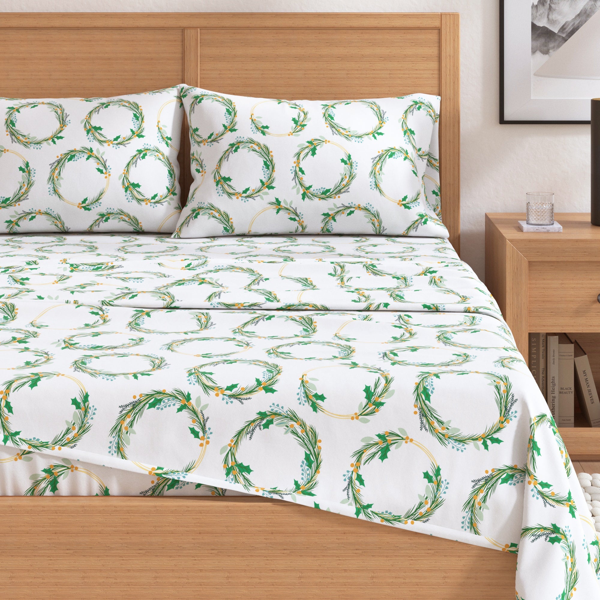 Bed with white sheets featuring green leaf patterns and matching pillowcases.