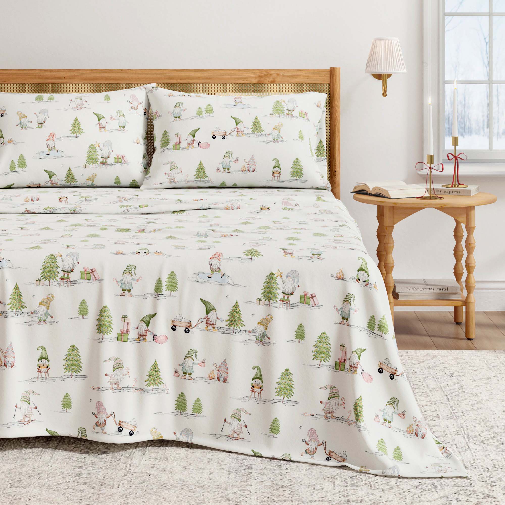 Bed with a patterned comforter and pillows in a room with a side table and lamp.
