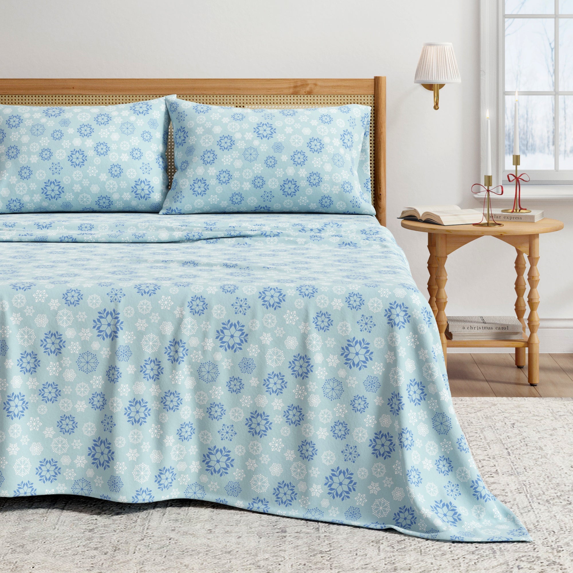 Blue floral patterned bedspread on a bed in a bedroom setting.