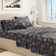 Floral patterned bedspread on a bed in a bedroom setting with a lamp and window.