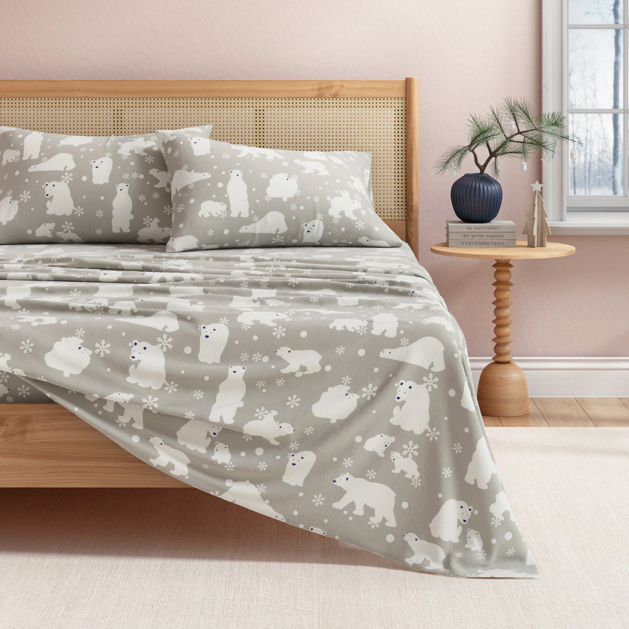 Bed with gray bedding featuring polar bear pattern in a bedroom setting.