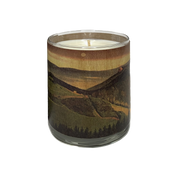 Candle in a glass jar with a mountain landscape design on a white background