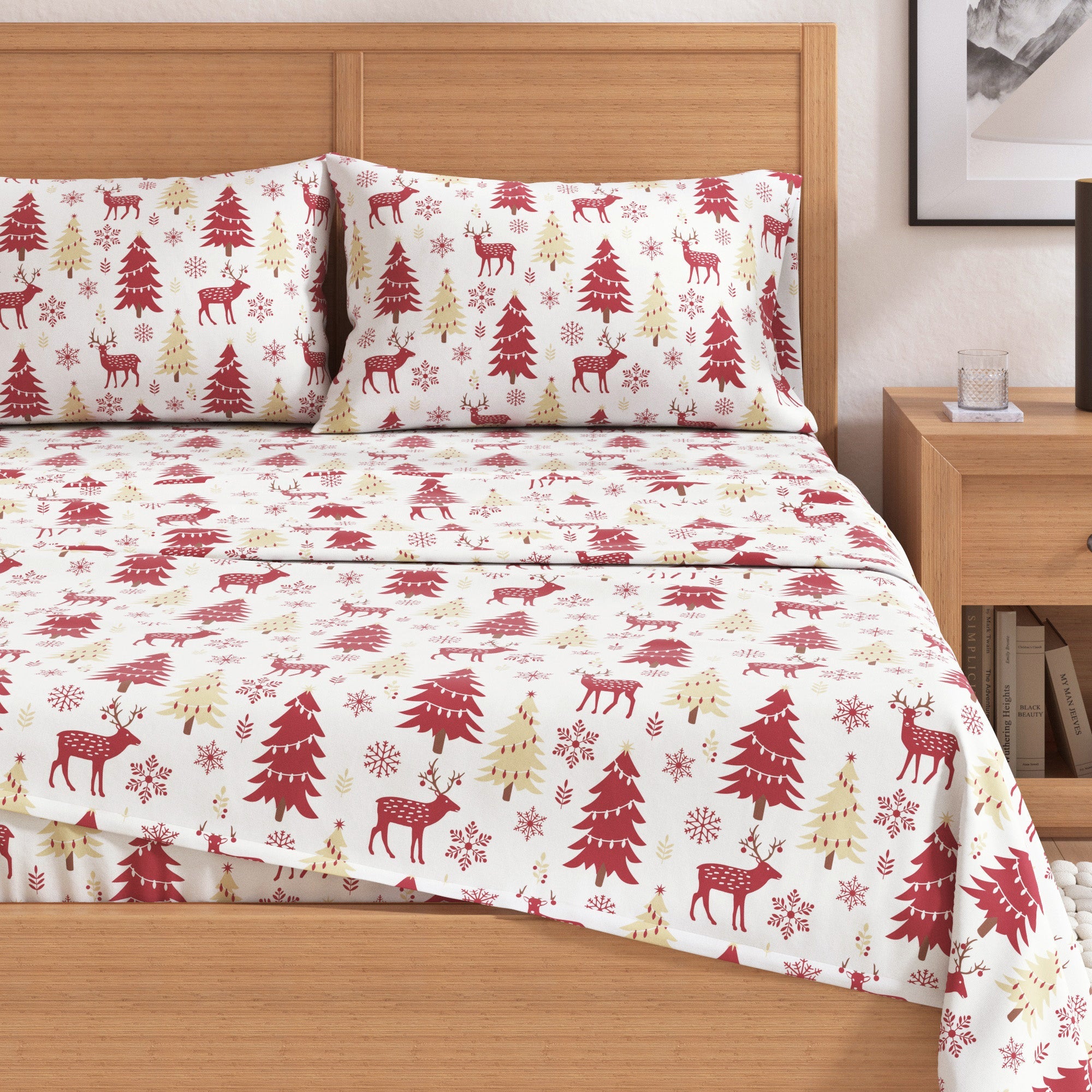 Christmas-themed bedspread with reindeer and trees on a wooden bed.
