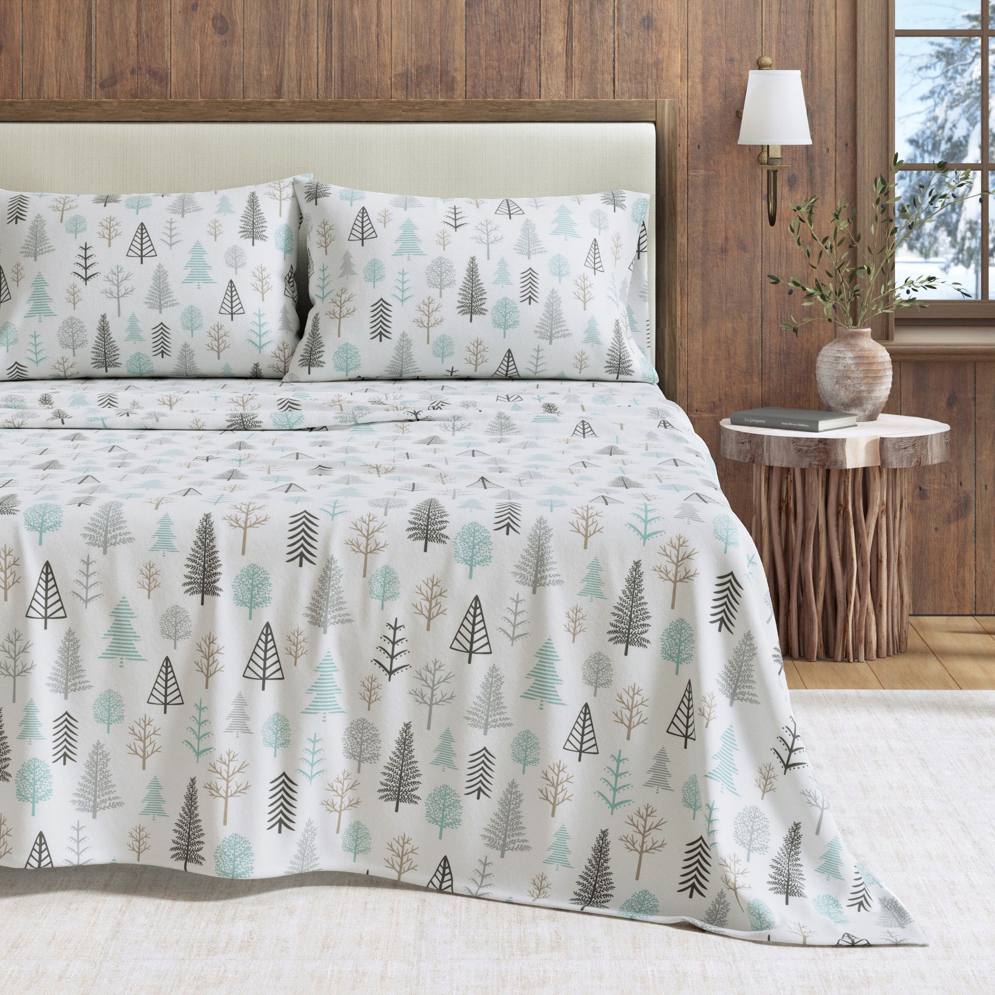 Bed with tree-patterned bedding in a bedroom setting