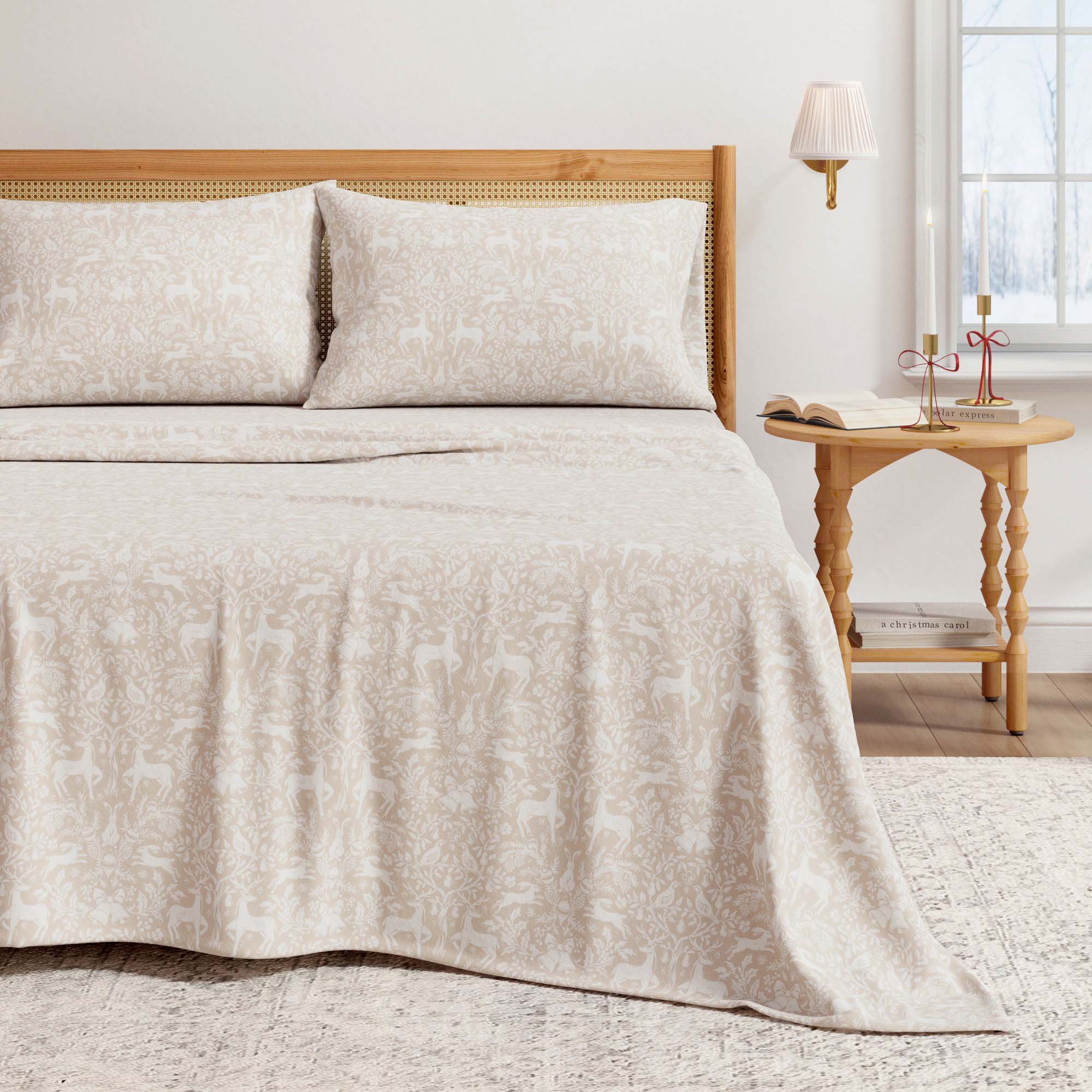 Beige bedspread on a bed with a wooden headboard and side table in a bedroom setting.