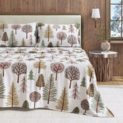 Bedding set with tree pattern on a bed in a bedroom setting.