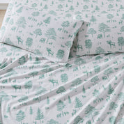 Sheet set with green forest pattern on white background