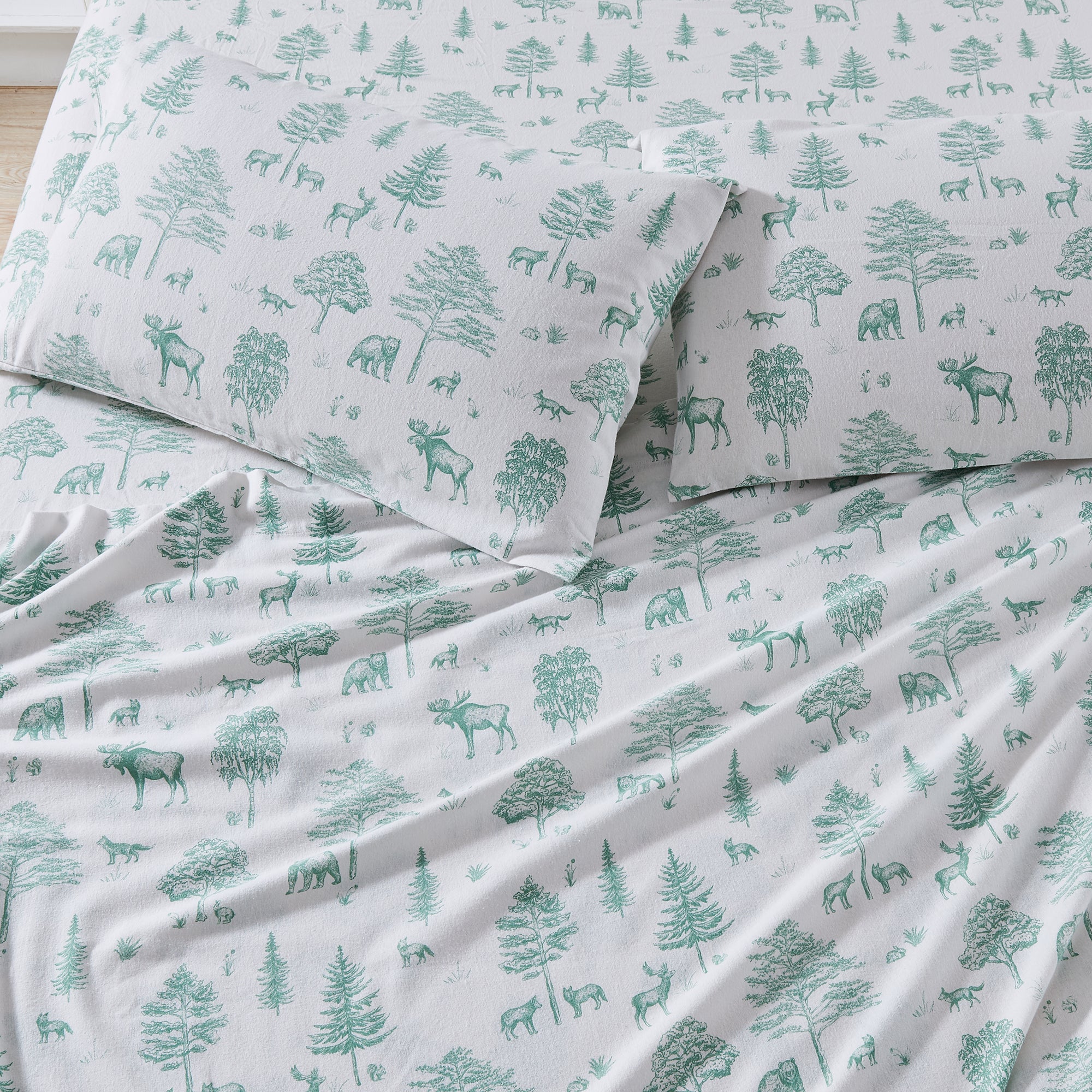 Sheet set with green forest pattern on white background